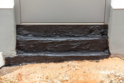 detail of insulation with Bitumen at an entrance door at the construction site
