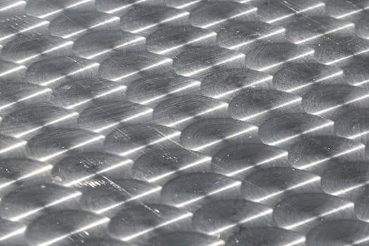 pattern of brushed silver plate with sun reflection gives a harmonic background