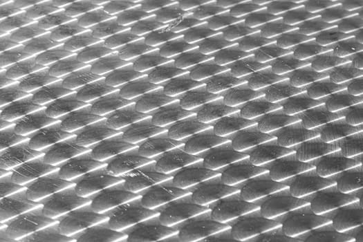 pattern of brushed silver plate with sun reflection gives a harmonic background