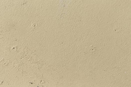 pattern of ochre painted old wall with irregularities