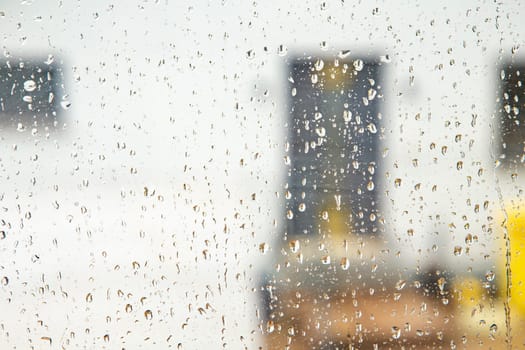 pattern of raindrops at the window in heavy rain