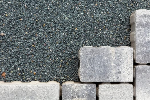 pattern of grey paving stones at a levelled chip foundation