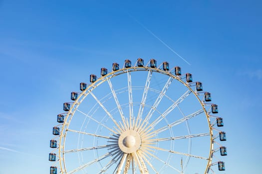 Ferris wheel in Stuttgart city under blue sky