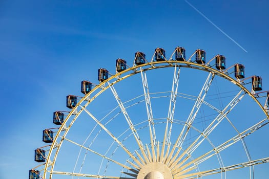 Ferris wheel in Stuttgart city under blue sky