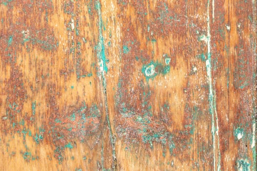 pattern of grunge wall in different colors on a wooden background with peeling old paint