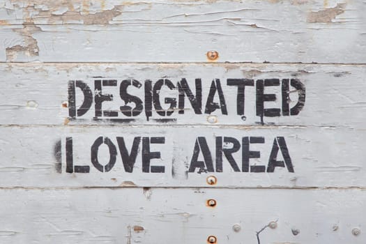 sign designated love area painted at a grey wall as love symbol