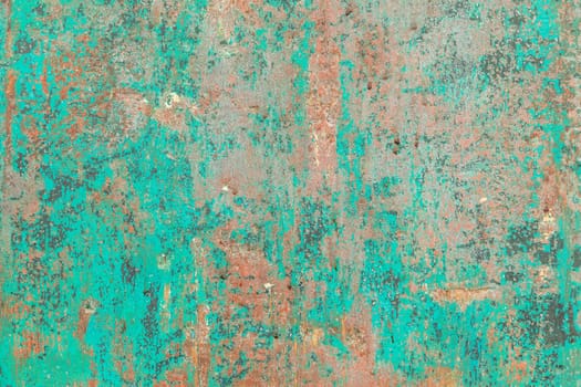 pattern of grunge wall with different colors covered by peeling green color in harmonic structure symbolizing age