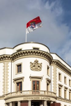view to parliament of Hesse in Wiesbaden, a former castle, with Hesse Flag at roof top under blue sky
