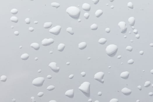 water drops on a white metal plate gives a harmonic background
