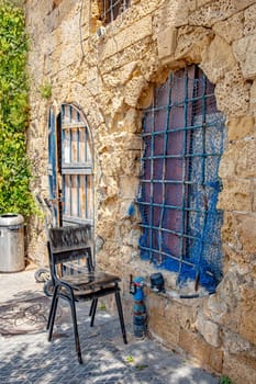idyllic restaurant with painted chair in an old building in the old town of Tel Aviv, Israel