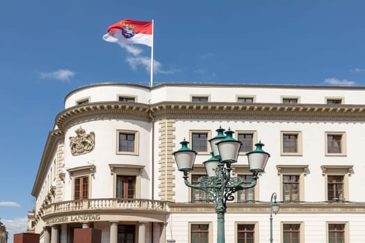 view to renovated facade of the Hesse parliament in Wiesbaden, Germany with fluttering flag
