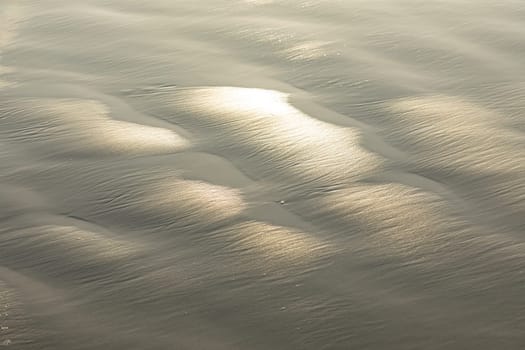 pattern of sand with water at the beach in harmonic structure