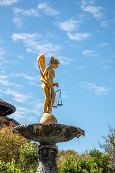 Lady Justice Statue on Water Fountain with San Antonio Downtown Building in Background, Texas, USA
