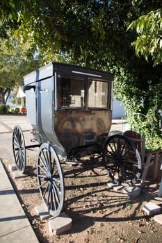 the Main Street in Fredericksburg, Texas with an amish horse carriage parking at the sidewalk