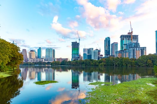 skyline of Austin in early morning light with mirroring city in the colorado river, Texas, USA