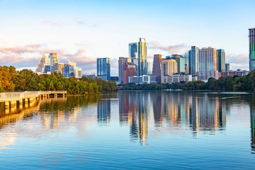 skyline of Austin in early morning light with mirroring city in the colorado river, Texas, USA