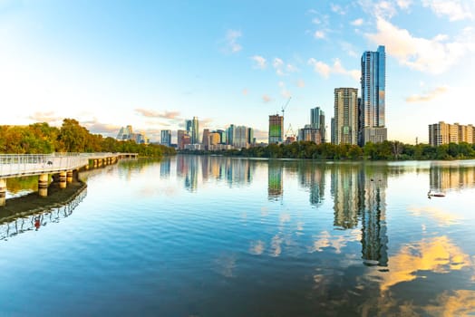 skyline of Austin in early morning light with mirroring city in the colorado river, Texas, USA