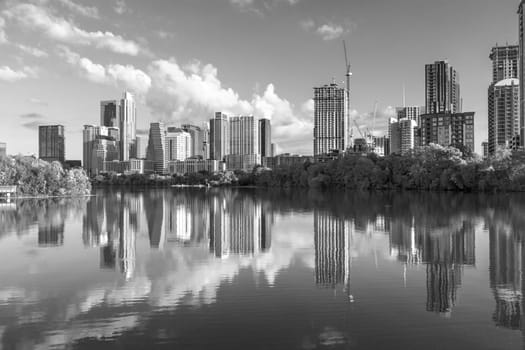 skyline of Austin in early morning light with mirroring city in the colorado river, Texas, USA