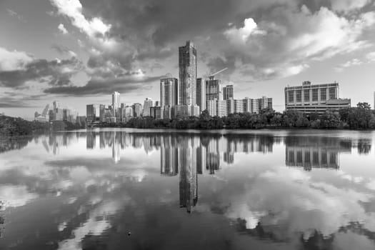 skyline of Austin in early morning light with mirroring city in the colorado river, Texas, USA