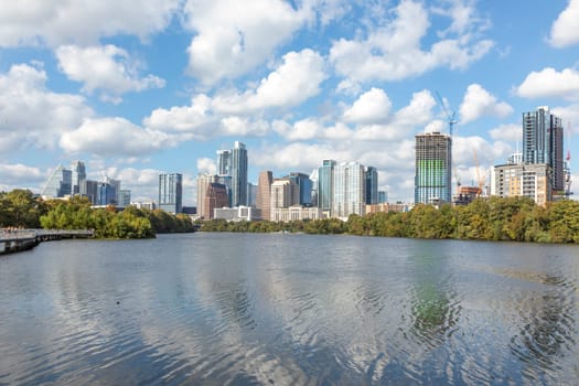 skyline of Austin in early morning light with mirroring city in the colorado river, Texas, USA