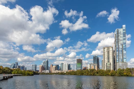 skyline of Austin in early morning light with mirroring city in the colorado river, Texas, USA