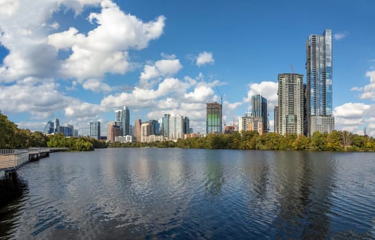 skyline of Austin in early morning light with mirroring city in the colorado river, Texas, USA
