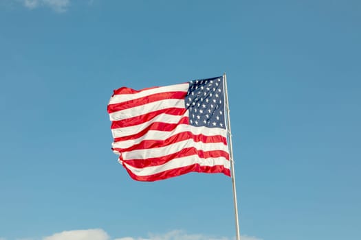 official usa flag stars and stripes fluttering in the wind