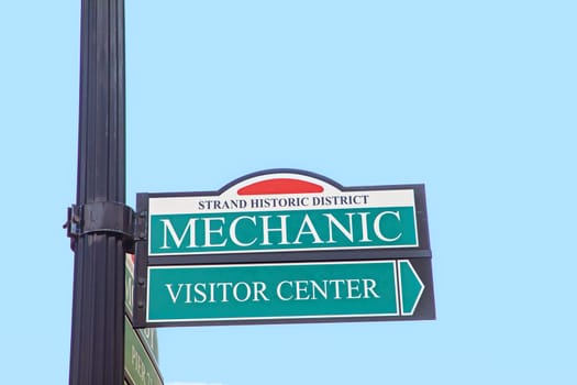 street sign Mechanic and visitor center at the old strand historic district in Galveston, Texas, USA