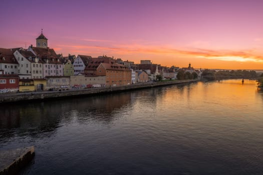 Historic cityscape of Regensburg at the river Daube during sunset