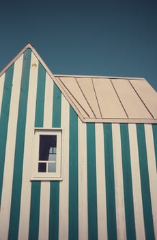 Little blue and white striped tiny house, close to the coast. Photography taken in France