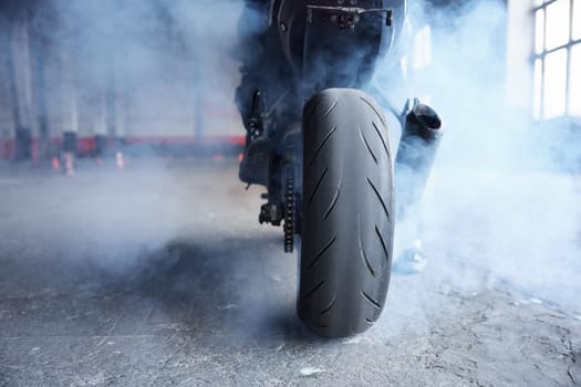 Motorcyclist squeezing clutch to start training race at motordrome. Driving school professional occupation