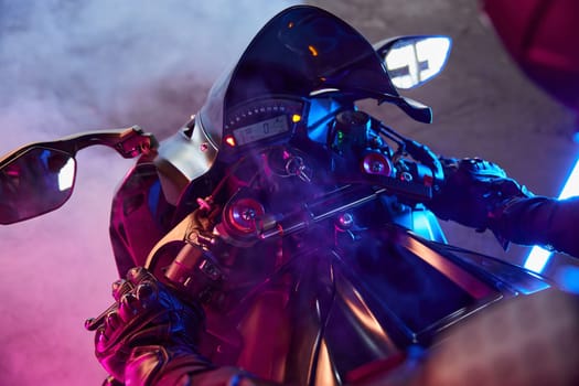 Closeup view of motorcycle dashboard in neon blue color illumination. Modern driving school for extreme speed riding learning and practicing