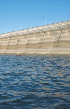 Float tube fisher close to Barragem do Caia wall, Campo Maior, Alentejo, Portugal