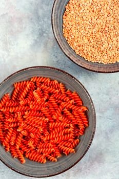 Dry red lentil fusilli pasta. Uncooked vegan pasta. Raw and dry macaroni.