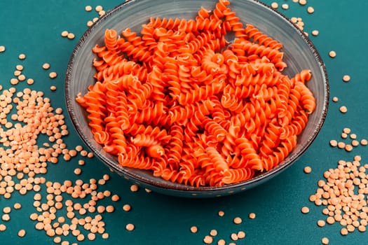 Dry red lentil fusilli pasta. Uncooked vegan pasta. Raw and dry macaroni.