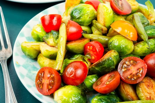 Vegetarian salad of roasted Brussels sprouts, tomatoes and green beans. Vegan food.