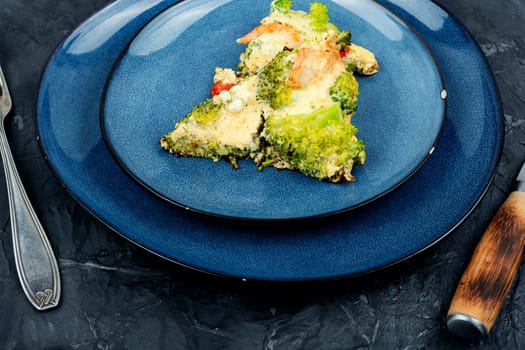 Roasted omelet with broccoli, cooked shrimp and tomato. Ketogenic lunch.