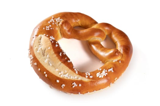 A Bavarian pretzel with salt on a white background. The pretzel is shaped like a knot and covered in a generous amount of salt. The pretzel is golden brown in color and looks crunchy and delicious.