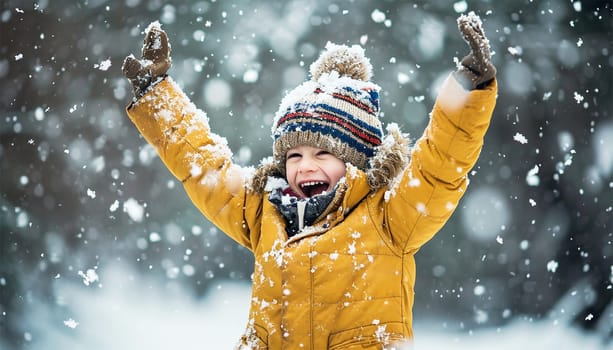 Winter concept. Child having fun in snow fall. winter clothes walks during a snowfall. Outdoors winter activities for kids. Cute child wearing a warm hat low over his eyes catching snowflakes cute