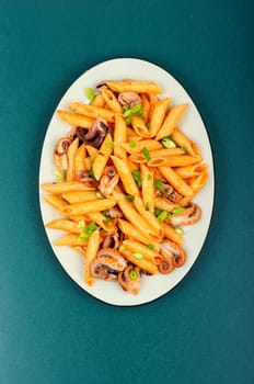 Delicious macaroni or pasta with octopus. Macaroni with seafood. American appetizer.