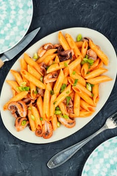 Delicious macaroni or pasta with octopus. Macaroni with seafood. American appetizer.