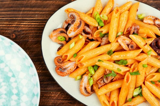 Delicious macaroni or pasta with octopus. Macaroni with seafood. American appetizer.