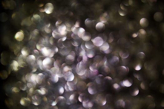 Black background with many purple and gold light points