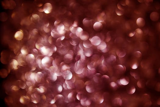Black background with lots of red and gold dots of light