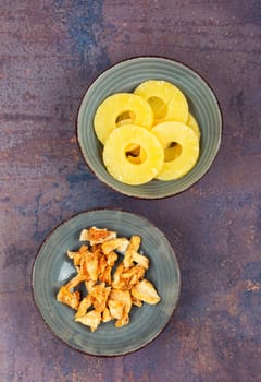 Delicious dry and fresh pineapples in bowls. Candy pineapples or ananas.