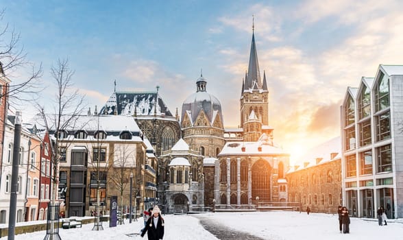 The famous Huge gothic cathedral of The Emperor Karl in Aachen Germany during winter season with snow at Katschhof against blue sky and sunshine background