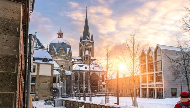 The famous Huge gothic cathedral of The Emperor Karl in Aachen Germany during winter season with snow at Katschhof against blue sky and sunshine background