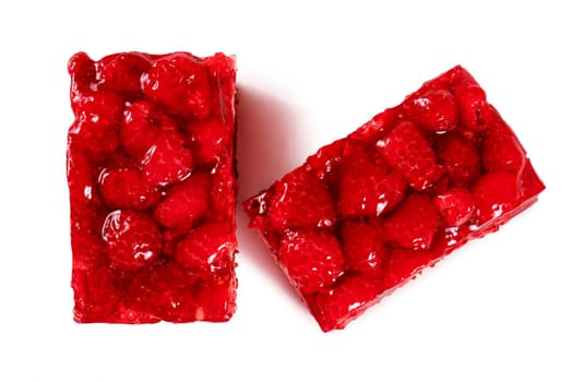 Two golden brown raspberry tarts, freshly baked and glistening with a generous layer of raspberry jam. The tarts are generously filled with plump raspberries, creating a beautiful burst of flavor and color. The tarts are displayed on a white background, showcasing their vibrant appearance