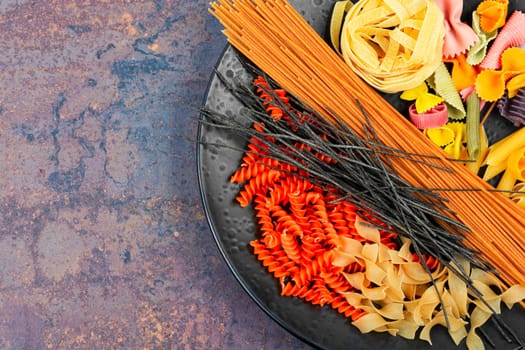 Different sorts of uncooked pasta, macaroni, noodles and spaghetti.