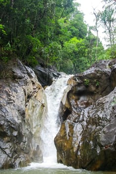Mountain river with a waterfall. Flowing mountain river natural landscape.